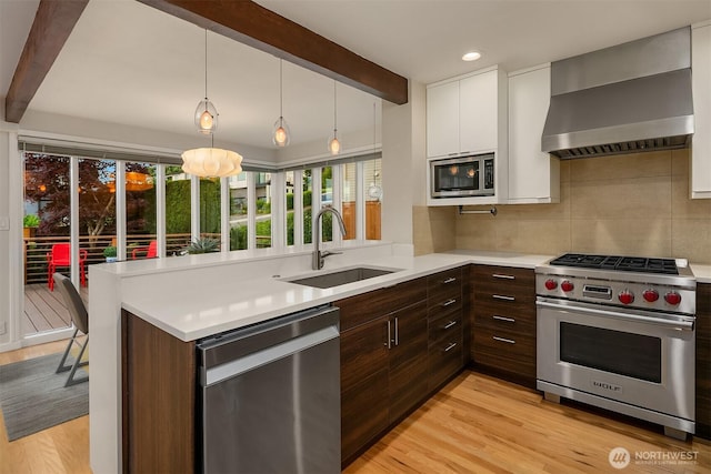 4439 158th Ave SE, Bellevue, WA 98006 - kitchen with stainless steel appliances, light countertops, wall chimney exhaust hood, beamed ceiling, and white cabinetry