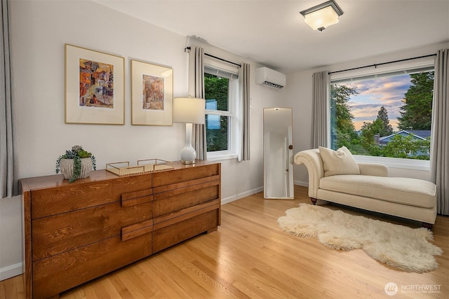4439 158th Ave SE, Bellevue, WA 98006 - sitting room featuring an AC wall unit, light wood-style flooring, and healthy amount of natural light