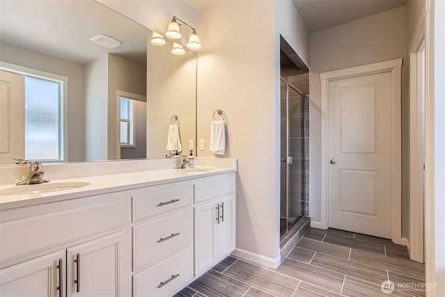 12911 NE 61st Ave, Vancouver, WA 98686 - full bathroom with double vanity, a shower stall, wood finish floors, and baseboards