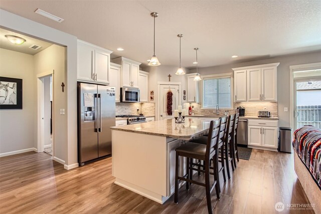 12911 NE 61st Ave, Vancouver, WA 98686 - kitchen with premium appliances, a center island, plenty of natural light, light wood-type flooring, and recessed lighting