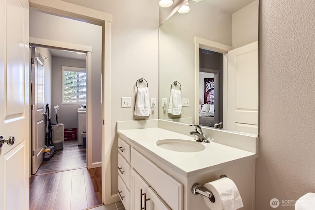 12911 NE 61st Ave, Vancouver, WA 98686 - bathroom with vanity, wood finished floors, and baseboards