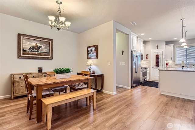 12911 NE 61st Ave, Vancouver, WA 98686 - dining area with a chandelier, light wood finished floors, baseboards, and recessed lighting