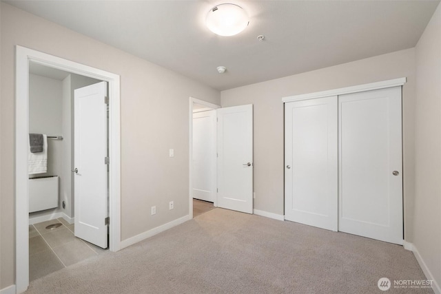 3123 148th St SW Unit A6, Lynnwood, WA 98087 - unfurnished bedroom with carpet flooring, baseboards, a closet, and ensuite bathroom