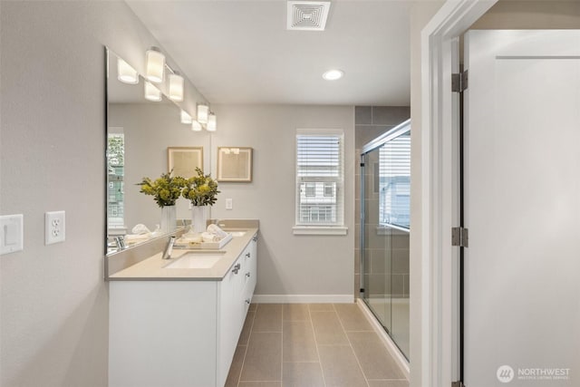 3123 148th St SW Unit A6, Lynnwood, WA 98087 - bathroom featuring double vanity, healthy amount of natural light, a stall shower, and recessed lighting