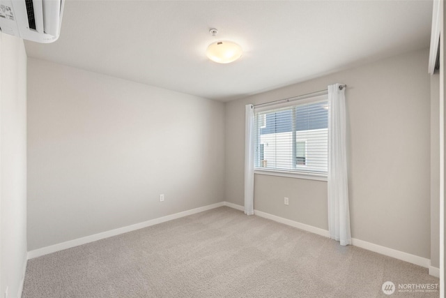 3123 148th St SW Unit A6, Lynnwood, WA 98087 - unfurnished room with light colored carpet, baseboards, and a wall mounted air conditioner