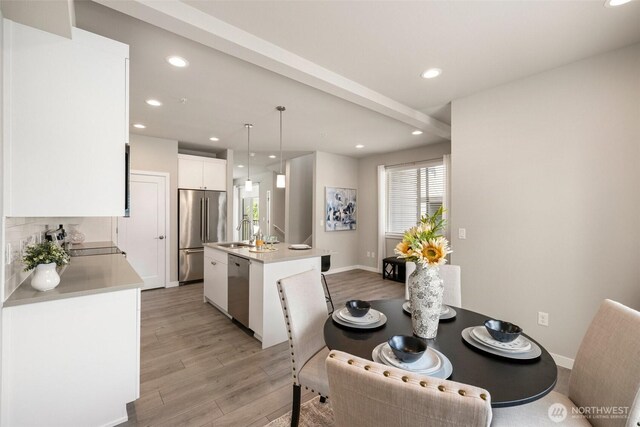 3123 148th St SW Unit A6, Lynnwood, WA 98087 - dining space featuring light wood-style flooring, recessed lighting, and baseboards