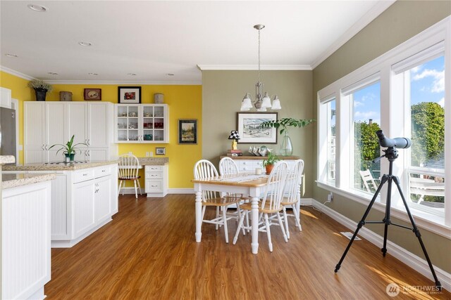 817 Shorecrest Dr, Oak Harbor, WA 98277 - dining room with baseboards, wood finished floors, ornamental molding, and a chandelier