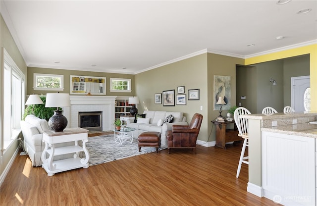 817 Shorecrest Dr, Oak Harbor, WA 98277 - living area featuring wood finished floors, baseboards, a fireplace, crown molding, and recessed lighting