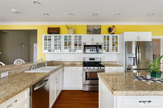 817 Shorecrest Dr, Oak Harbor, WA 98277 - kitchen featuring stainless steel appliances, a sink, ornamental molding, light stone countertops, and white cabinets