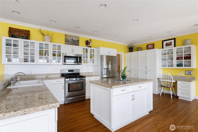 817 Shorecrest Dr, Oak Harbor, WA 98277 - kitchen featuring appliances with stainless steel finishes, a sink, dark wood finished floors, ornamental molding, and tasteful backsplash