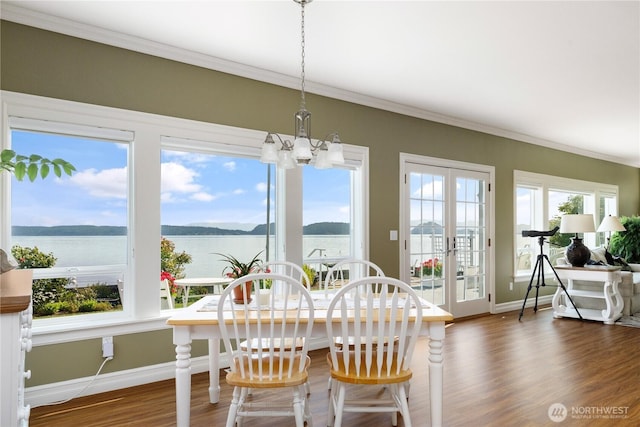 817 Shorecrest Dr, Oak Harbor, WA 98277 - dining space with baseboards, a chandelier, crown molding, wood finished floors, and a water view