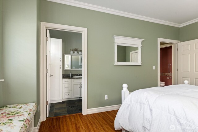 817 Shorecrest Dr, Oak Harbor, WA 98277 - bedroom featuring crown molding, a sink, baseboards, dark wood-style floors, and ensuite bathroom