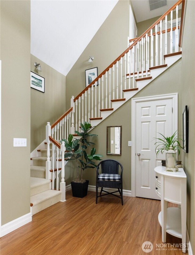 817 Shorecrest Dr, Oak Harbor, WA 98277 - stairs with wood finished floors, high vaulted ceiling, and baseboards