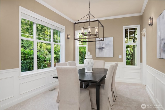 4503 229th Pl SE, Sammamish, WA 98075 - dining room with a chandelier, light colored carpet, a decorative wall, wainscoting, and crown molding