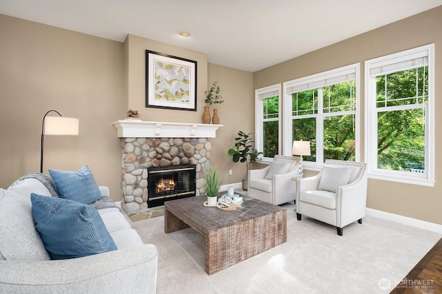 4503 229th Pl SE, Sammamish, WA 98075 - living room with plenty of natural light, baseboards, a stone fireplace, and light wood finished floors