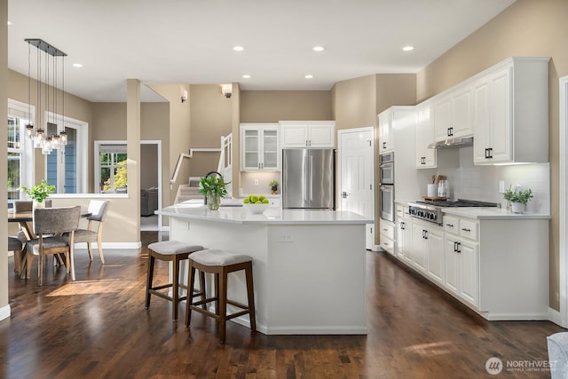 4503 229th Pl SE, Sammamish, WA 98075 - kitchen with appliances with stainless steel finishes, baseboards, decorative backsplash, a kitchen island, and white cabinets