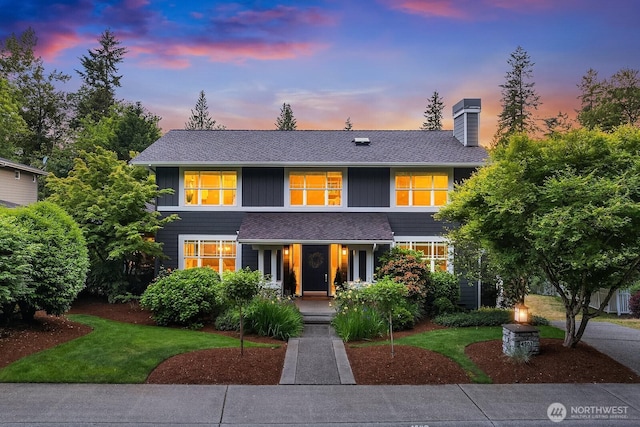 4503 229th Pl SE, Sammamish, WA 98075 - view of front facade featuring a chimney, a front lawn, covered porch, and a shingled roof