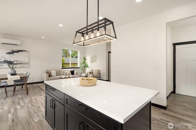 9245 Kelsey Ln SW, Seattle, WA 98106 - kitchen featuring a wall mounted AC, light wood-style flooring, light countertops, recessed lighting, and a kitchen island