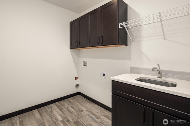 9245 Kelsey Ln SW, Seattle, WA 98106 - laundry area featuring washer hookup, cabinet space, hookup for an electric dryer, and light wood-style floors
