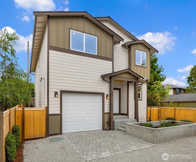 9245 Kelsey Ln SW, Seattle, WA 98106 - modern home with board and batten siding, an attached garage, and decorative driveway