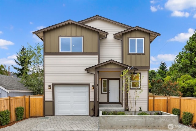 9245 Kelsey Ln SW, Seattle, WA 98106 - view of front of house featuring a garage, decorative driveway, and board and batten siding