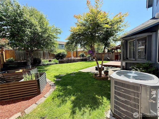 4304 Seville Dr SE, Lacey, WA 98503 - view of yard featuring central air condition unit, a deck, and a vegetable garden