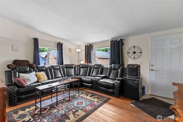 2614 48th Ave, Longview, WA 98632 - living area with wood finished floors, plenty of natural light, vaulted ceiling, and a textured ceiling
