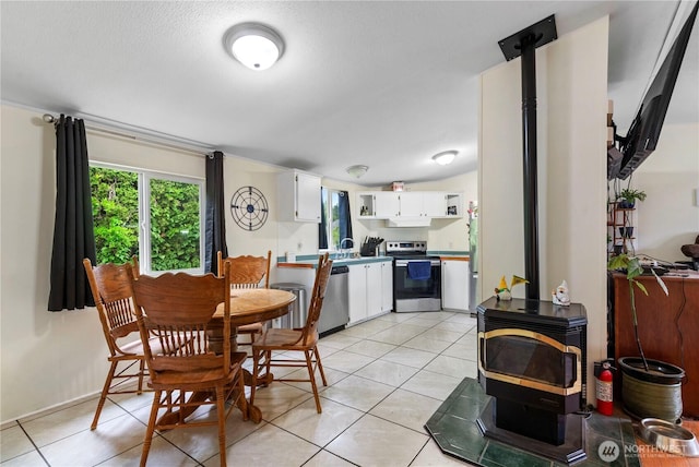 2614 48th Ave, Longview, WA 98632 - dining space with a wood stove and light tile patterned flooring