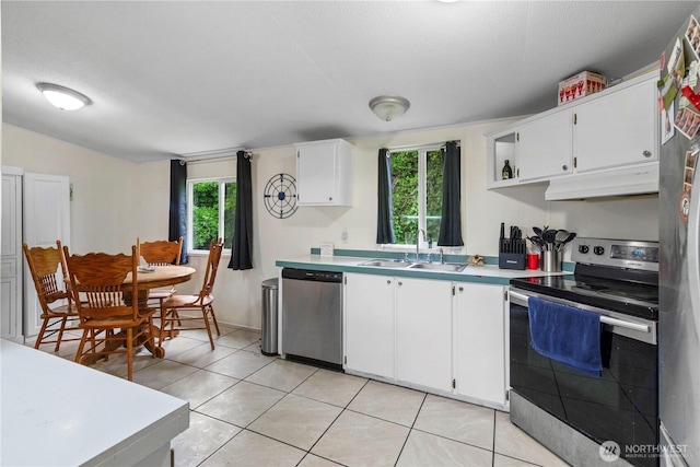 2614 48th Ave, Longview, WA 98632 - kitchen with appliances with stainless steel finishes, under cabinet range hood, a sink, healthy amount of natural light, and a textured ceiling