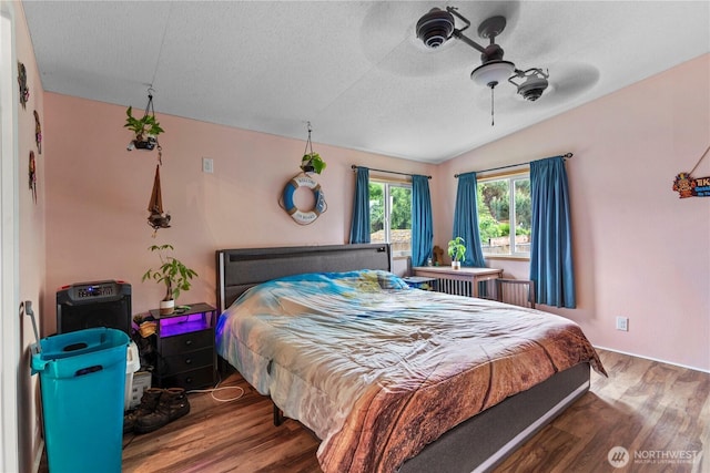 2614 48th Ave, Longview, WA 98632 - bedroom with wood finished floors, vaulted ceiling, a textured ceiling, and ceiling fan