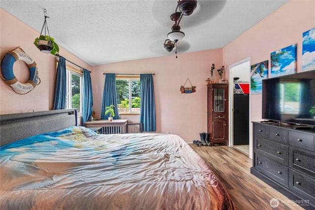 2614 48th Ave, Longview, WA 98632 - bedroom featuring wood finished floors, vaulted ceiling, a textured ceiling, and ceiling fan