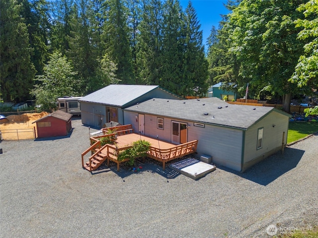 16605 259th Avenue Ct E, Buckley, WA 98321 - rear view of house with a wooden deck and an outdoor structure