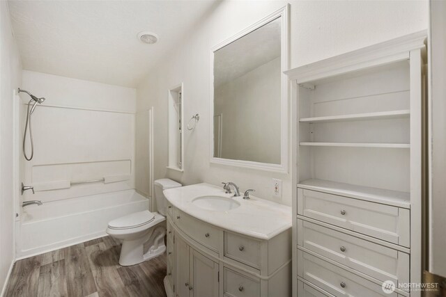 16605 259th Avenue Ct E, Buckley, WA 98321 - bathroom featuring vanity, wood finished floors, bathtub / shower combination, and toilet