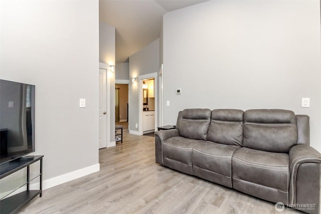 28209 241st Ave SE, Maple Valley, WA 98038 - living area featuring baseboards, light wood finished floors, and high vaulted ceiling