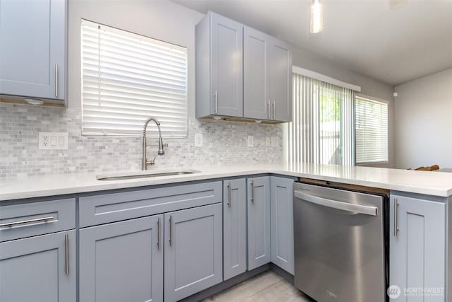 28209 241st Ave SE, Maple Valley, WA 98038 - kitchen featuring dishwasher, a sink, gray cabinets, a peninsula, and light countertops