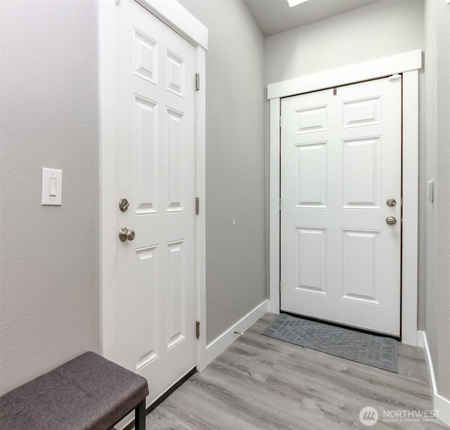 28209 241st Ave SE, Maple Valley, WA 98038 - doorway to outside featuring light wood-style floors and baseboards