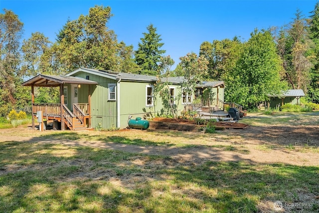 7459 SW 255th St, Vashon, WA 98070 - rear view of house with a lawn and a wooden deck