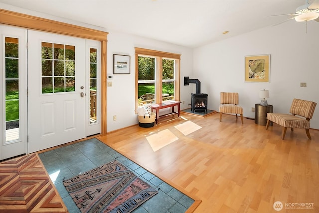 7459 SW 255th St, Vashon, WA 98070 - foyer featuring lofted ceiling, a wood stove, wood finished floors, and ceiling fan