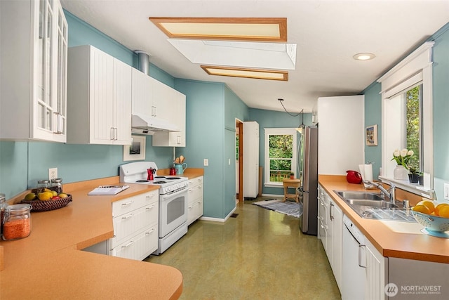 7459 SW 255th St, Vashon, WA 98070 - kitchen featuring white electric stove, freestanding refrigerator, under cabinet range hood, finished concrete flooring, and a sink