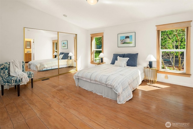 7459 SW 255th St, Vashon, WA 98070 - bedroom with hardwood / wood-style floors, vaulted ceiling, and a closet