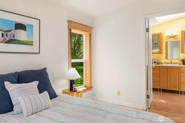 7459 SW 255th St, Vashon, WA 98070 - bedroom with a sink, ensuite bath, and baseboards