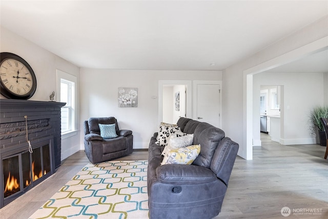 2333 31st Ave S, Seattle, WA 98144 - living area featuring a brick fireplace, baseboards, and wood finished floors