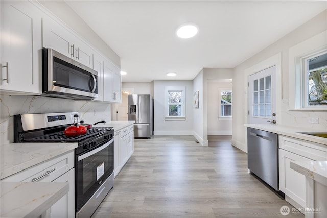 2333 31st Ave S, Seattle, WA 98144 - kitchen featuring appliances with stainless steel finishes, healthy amount of natural light, baseboards, white cabinets, and recessed lighting