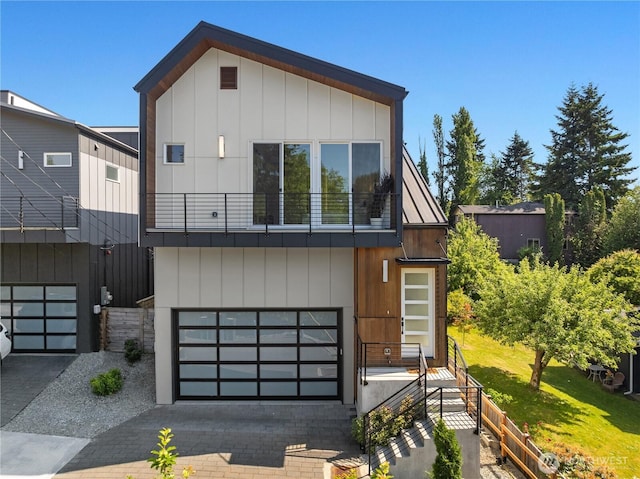 10227 26th Ave SW, Seattle, WA 98146 - view of front of property featuring a balcony, a garage, and driveway