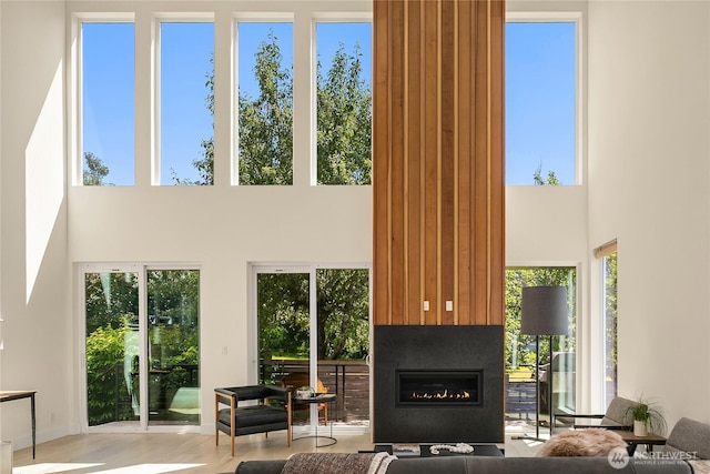 10227 26th Ave SW, Seattle, WA 98146 - living room featuring a towering ceiling, a fireplace, and wood finished floors