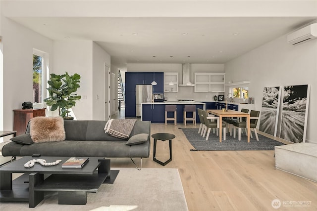 10227 26th Ave SW, Seattle, WA 98146 - living room with light wood-type flooring, a wall unit AC, and recessed lighting