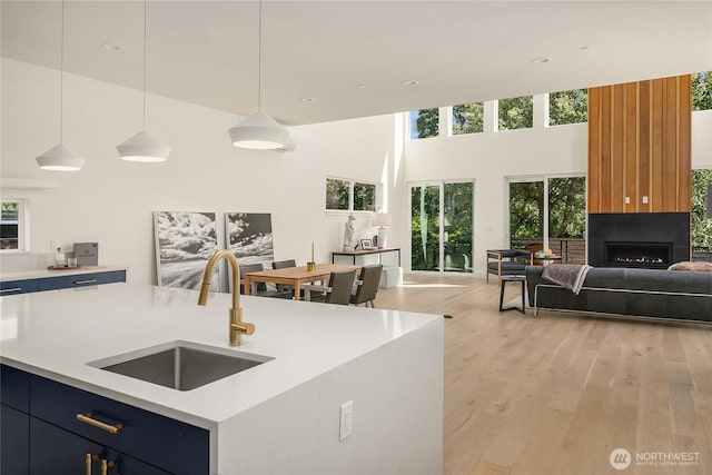 10227 26th Ave SW, Seattle, WA 98146 - kitchen featuring a sink, open floor plan, light countertops, a towering ceiling, and healthy amount of natural light