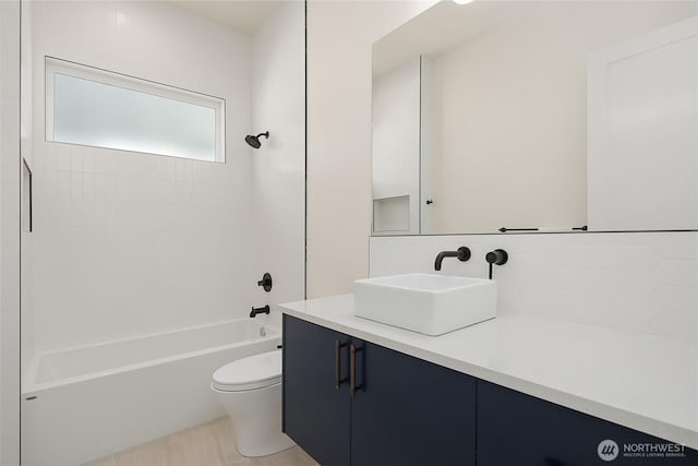 10227 26th Ave SW, Seattle, WA 98146 - bathroom with vanity, toilet, shower / tub combination, and tasteful backsplash