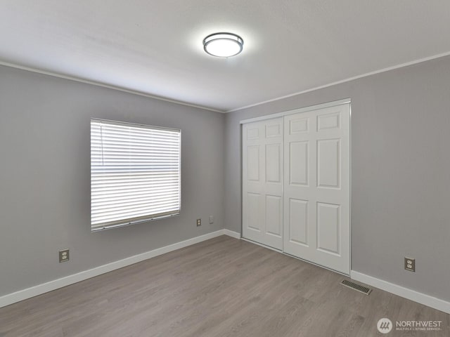 27460 149th Pl SE Unit 85, Kent, WA 98042 - unfurnished bedroom featuring wood finished floors, a closet, and baseboards
