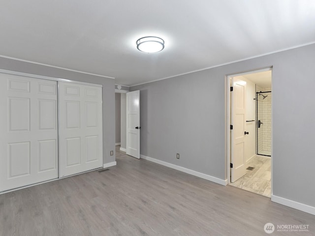 27460 149th Pl SE Unit 85, Kent, WA 98042 - unfurnished bedroom featuring wood finished floors, crown molding, baseboards, a closet, and ensuite bathroom